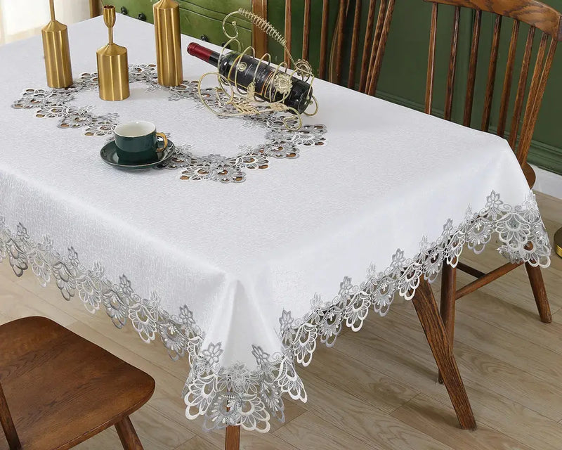 White lace embroidery tablecloth with intricate floral patterns and scalloped edges. Ideal for dining tables, weddings, and special occasions.