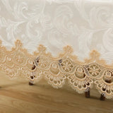 White lace embroidery tablecloth with intricate floral patterns and scalloped edges. Ideal for dining tables, weddings, and special occasions.