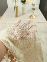 Elegant beige dining tablecloth with intricate lace design and decorative tassels