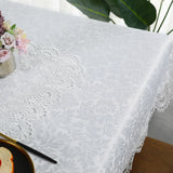  Ivory lace embroidery tablecloth with floral patterns on a dining table. Elegant and waterproof, suitable for weddings and home decor.