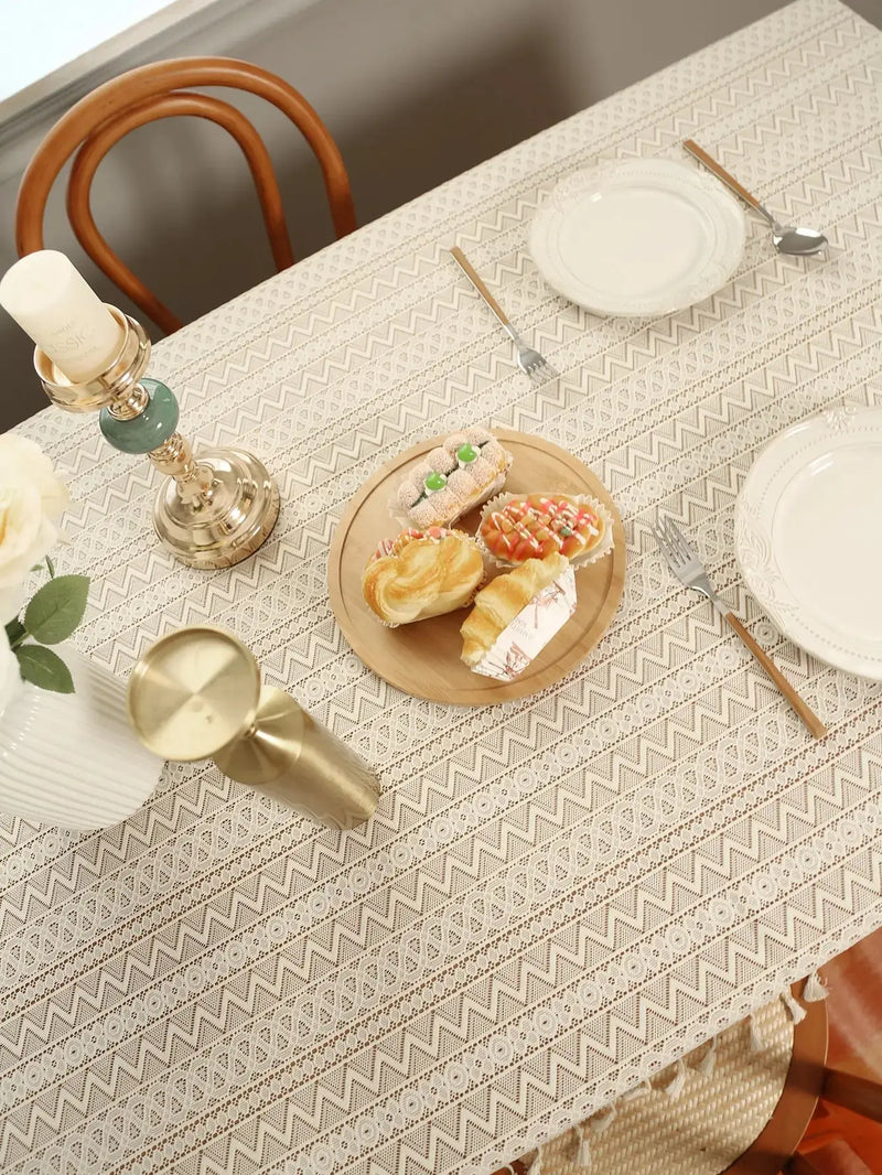 Elegant beige dining tablecloth with intricate lace design and decorative tassels