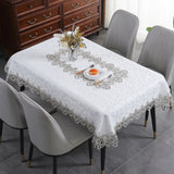 Battilo lace embroidery tablecloth with delicate floral patterns on a modern dining table. Stylish and waterproof for home and event use.