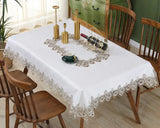 White lace embroidery tablecloth with intricate floral patterns and scalloped edges. Ideal for dining tables, weddings, and special occasions.