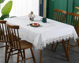 White lace embroidery tablecloth with intricate floral patterns and scalloped edges. Ideal for dining tables, weddings, and special occasions.